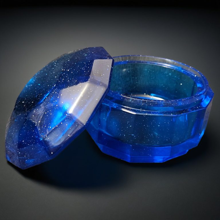 Blaue handgefertigte, glitzernde Kristalldose aus Harz mit facettierter Oberfläche und rundem Deckel.